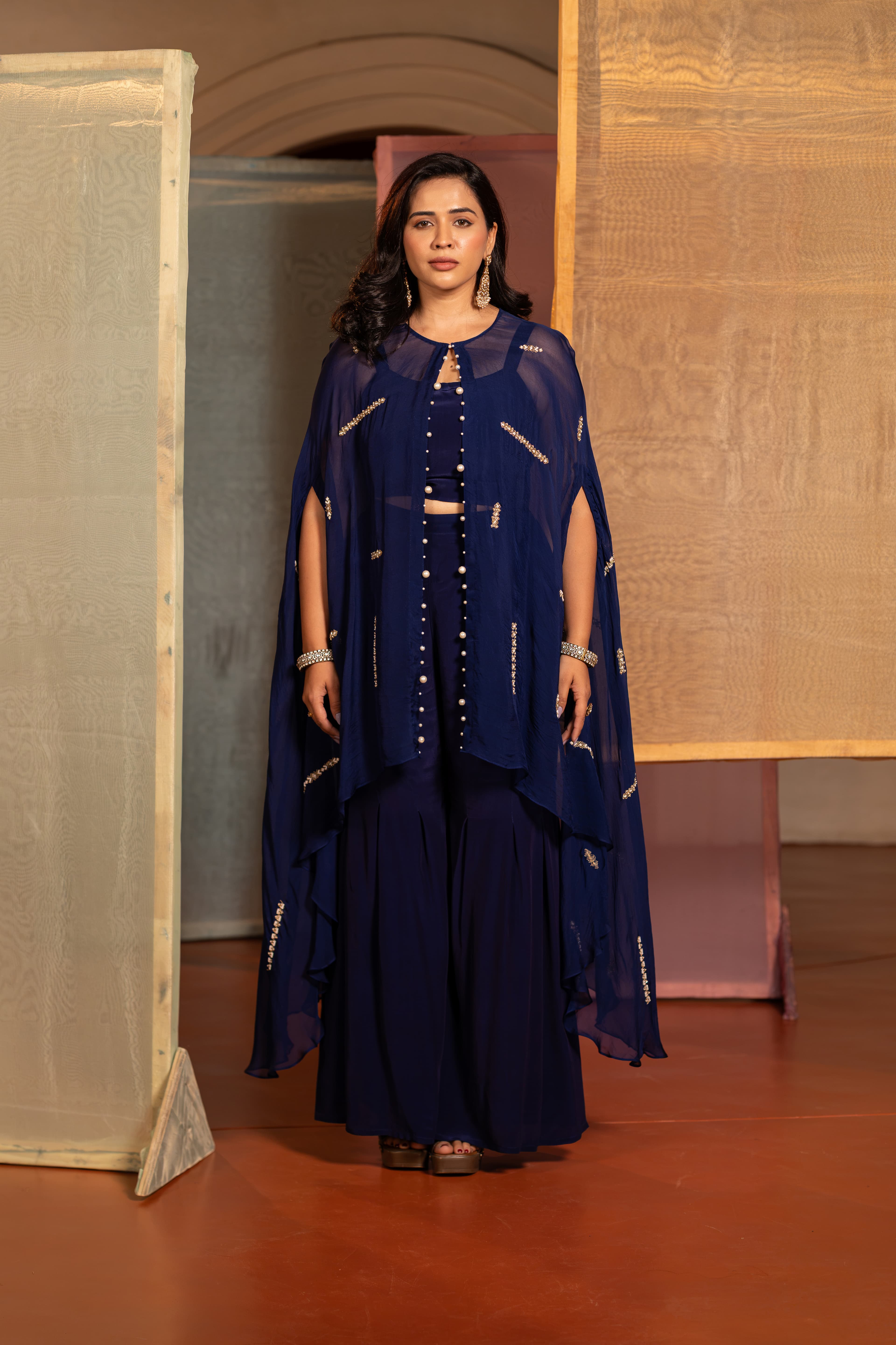 A contemporary navy-blue Indo Western set defined by sheer layer and refined handwork detail.