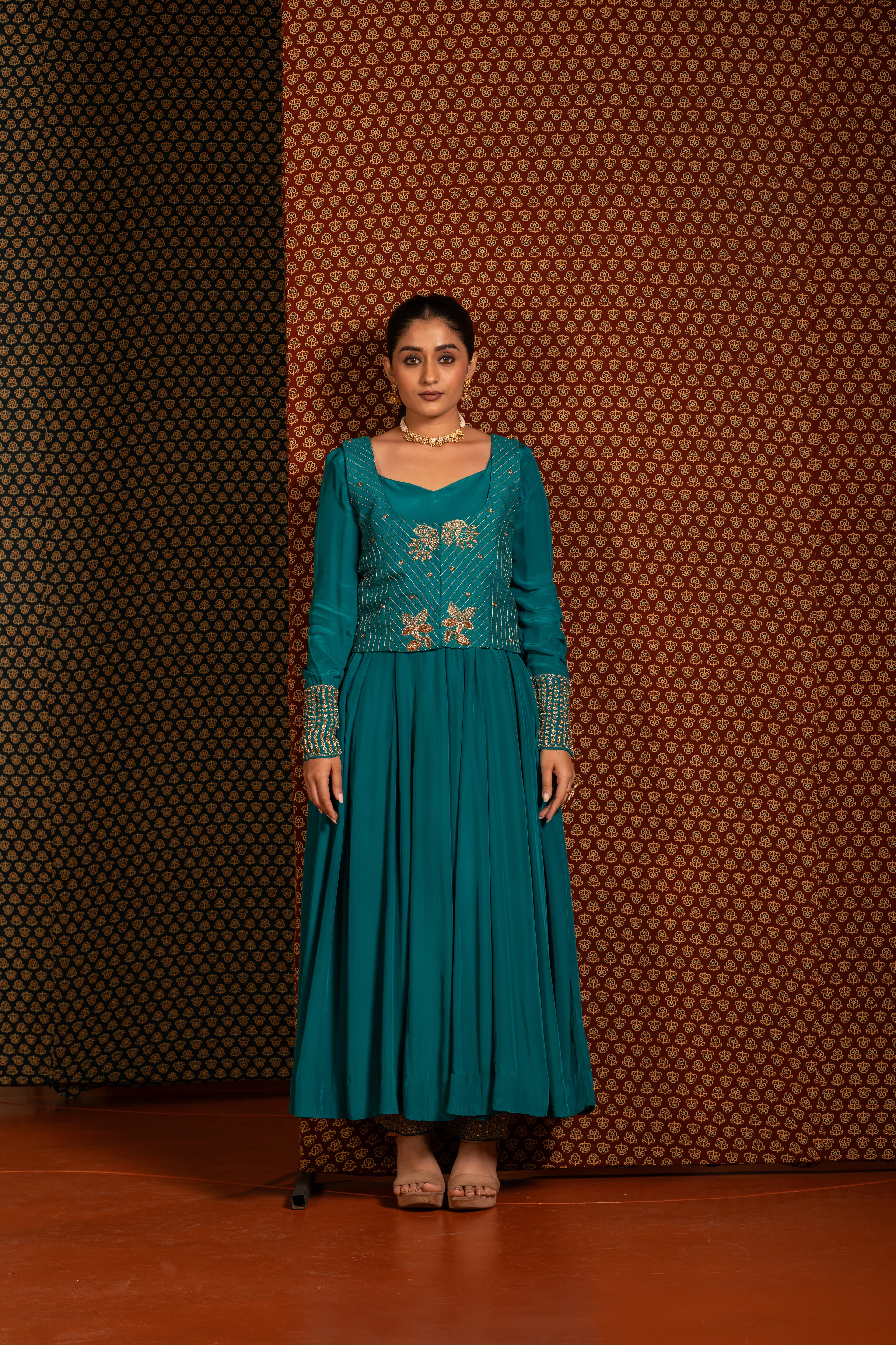 Teal Green Anarkali set paired with a jacket, featuring intricate traditional handwork